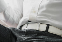Load image into Gallery viewer, man sitting white belt on black dress pants wearing white shirts