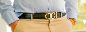 male wearing tonywell black gold buckle ratchet belt hands inside pocket light blue shirt khaki dress pants
